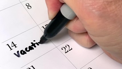 Vacation written in black marker on a calendar agenda page