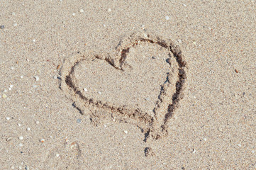 Fototapeta na wymiar hearts on the sand near the sea