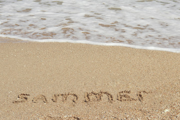 summer inscription in the sand near the sea