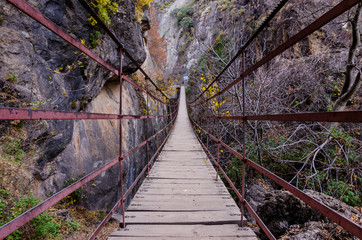 Hiking trail Los Cahorros de Monachil (Granada) in Autumn. Impressive gorge carved by the Monachil River. It is a place of singular beauty with waterfalls, caves and suspension bridges.