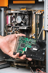 Fototapeta premium Closeup image of technician man hand changing the hard drive of pc computer . Maintenance and repair computer hardware service concept .