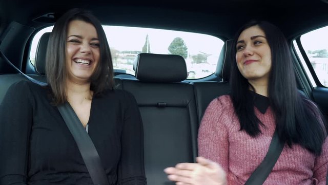 Concept of friendship between women laughing in car having fun