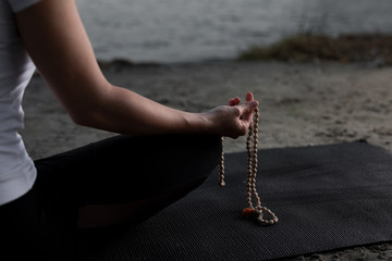 Beautiful young woman is practicing yoga in the nature