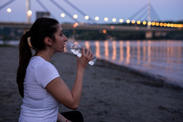 Beautiful young woman is meditating on the beach