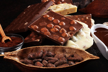 Melting chocolate, melted chocolate and chocolate swirl with stack and chips on table