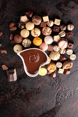 a lot of variety chocolate pralines, belgian confectionery gourmet chocolate on rustic dark background