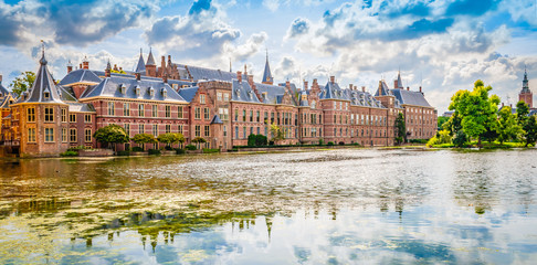 Panoramic landscape view with popular parliament building of the Binnenhof at a beautiful pond ,...