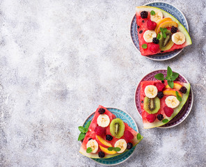 Watermelon pizza with fruit and berries