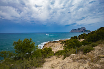 Fototapeta na wymiar Mediterranean pines in a city park in Moraira overlooking Playa El Portet beach in Mediterranean Alicante, Spain