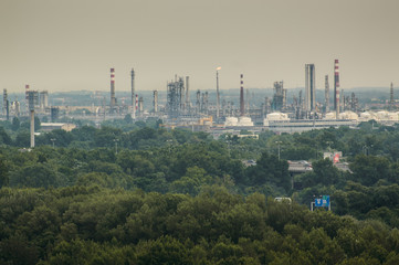 Bratislava, an oil refinery, numerous chimneys on the background of forests.
