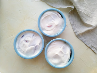 Casserole in round blue shapes before baking on a light background top view.
