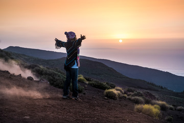 people enjoying open nature at the mountain during sunset -active woman in outdoor leisure activity with open arms - freedom and alternative lifestyle travel concept