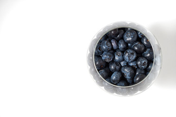Closeup berries in a glass vase on a white background. glass vase on a white background . Top view and free space