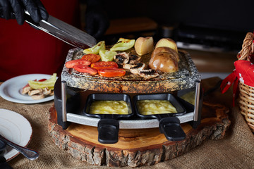 Swiss raclette. A table filled with ingredients.