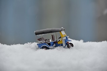 model tuk tuk taxi toy on snow