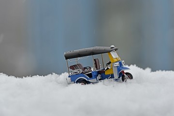 model tuk tuk taxi toy on snow