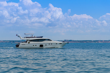 Small yacht in motion on the sea during the summer season