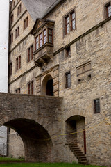 Fototapeta na wymiar Architectural detail of the Wewelsburg castle with brick construction, hidden staircase and door on the canal level and main entrance portal above