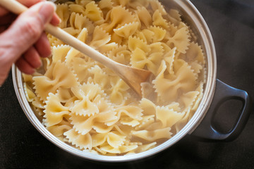 Farfalle pasta cooking in a pot.