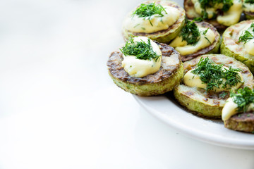homemade zucchini fried with mayonnaise. On a white background
