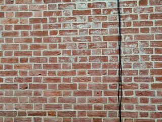 Brick wall with black cable, victorian, clay bricks