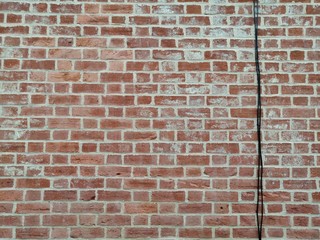 brick wall with black cable