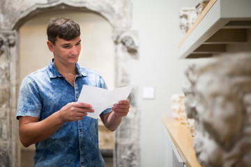 Man visiting museum with leaflet