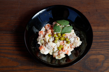 Olivier vegetable salad of home cooking, closeup photo.
