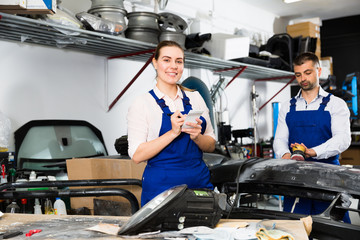 Female mechanic recording list of works