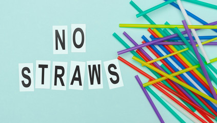 Colorful straws near ecological writing