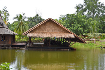 Fototapeta premium Kanchanaburi, Thailand, 09.09.2019: Beautiful garden, lake, traditional Thai, Siamese clothes, buildings of 