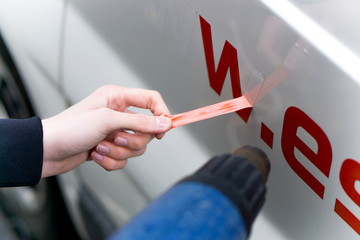 Remove the adhesive letter from the car