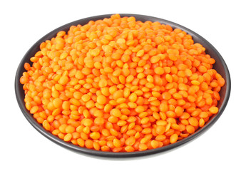 Pile lentil in black bowl isolated on white background