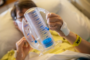 Patient Does Breathing Treatments at Hospital After Surgery