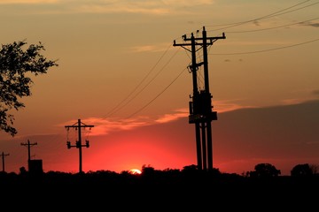 Kansas Sunset with power lines and wires with clouds.