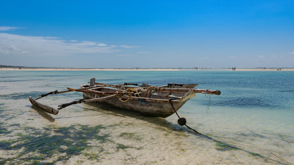 old fishing boat on the beach of zanzibar
