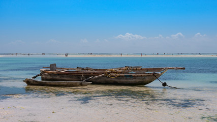 old fishing boat on the beach of zanzibar