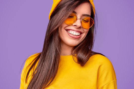 Cheerful lady in yellow sunglasses