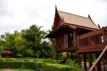 Kanchanaburi, Thailand, 09.09.2019: Beautiful garden, lake, traditional Thai, Siamese clothes, buildings of "Mallika City R.E. 124" a heritage, retro-city reflecting the real past Siamese lifestyle