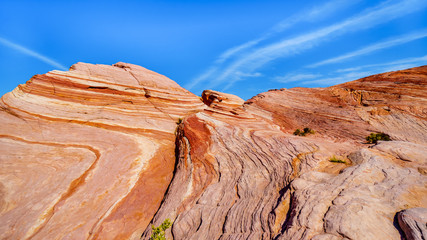 The colorful red, yellow and white banded rock formations along the Fire Wave Trail in the Valley of Fire State Park in Nevada, USA