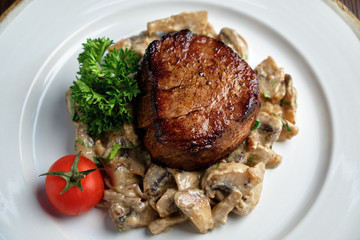 Meat medallion with mushrooms. restaurant menu