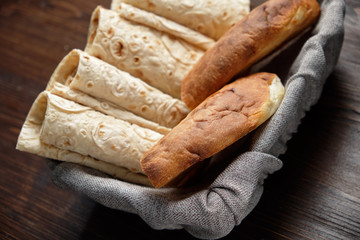 Pita bread of different types in a bread basket . restaurant menu