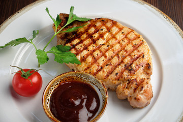 Steak on the bone with red sauce. restaurant menu
