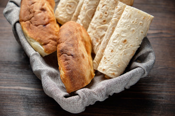 Pita bread of different types in a bread basket . restaurant menu