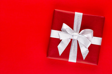 Christmas holiday present box on red background.