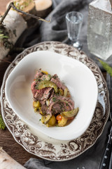 Steak salad with potatoes, gherkins and marinated red onion