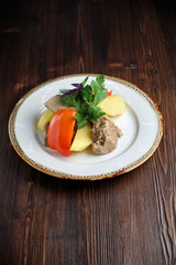 Boiled meat with a side dish and vegetables . restaurant menu