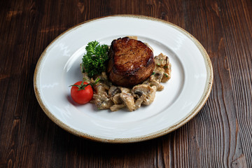Meat medallion with mushrooms. restaurant menu