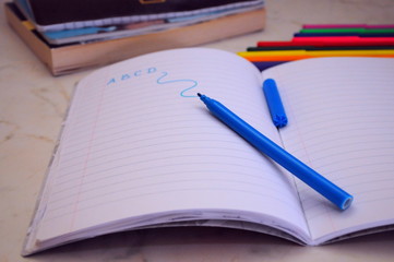 Naklejka premium notebook and pen on white background