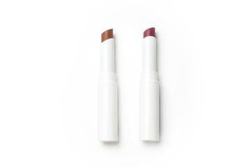 white lip stick colored in red pink purple orange on white background 